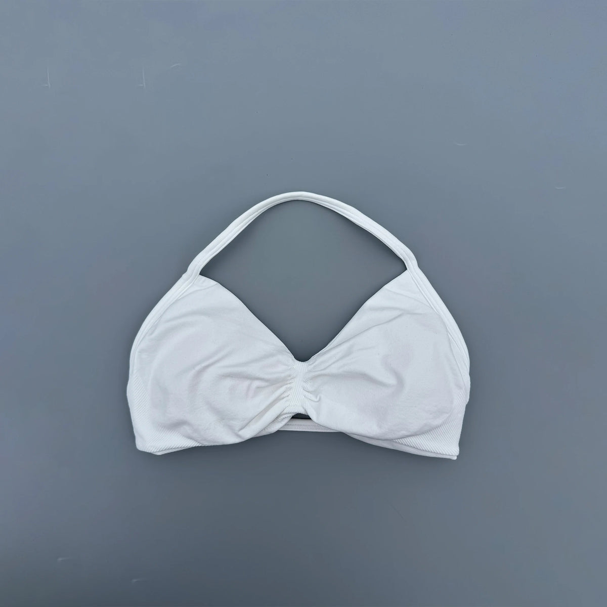 White bikini top on a gray background