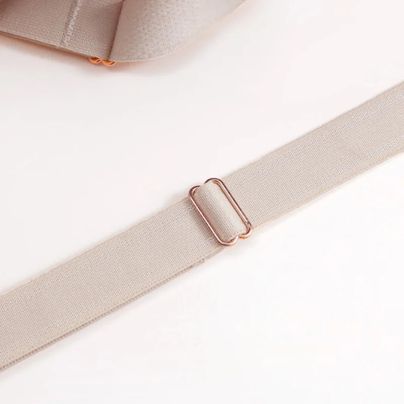 Close-up of a beige adjustable strap with a rose gold metal slider buckle on a clean white background.