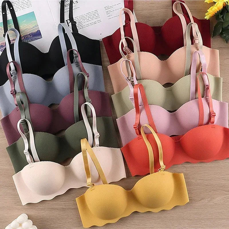 Collection of colorful bras displayed on a wooden surface.