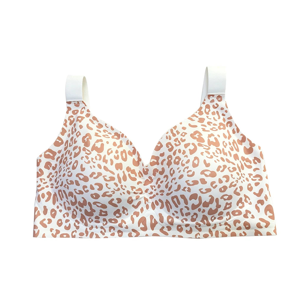 A wireless underwire bra with a white and light brown leopard print pattern, featuring solid white shoulder straps, shown against a plain white background.