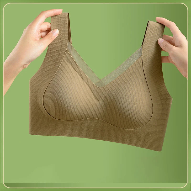 Brown bra held by hands against a green background