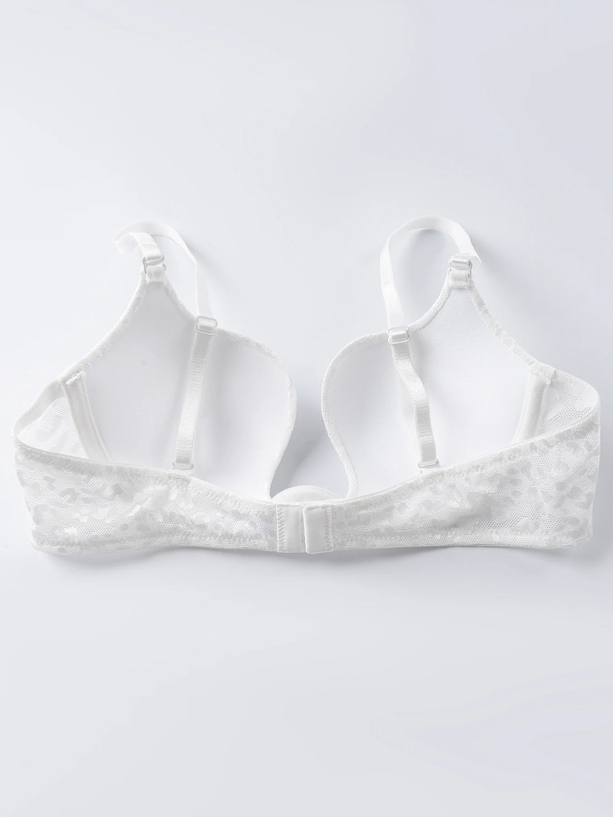 White underwire bra with lace cups and adjustable shoulder straps, laid flat on a light gray background.