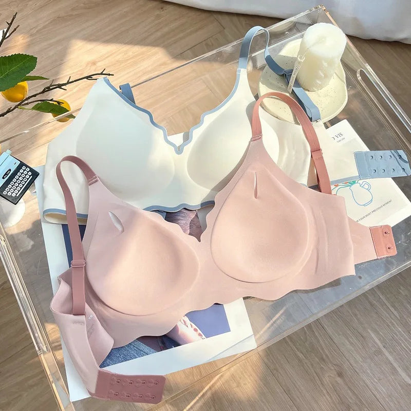 Pink bra on a clear acrylic stand with a blurred background