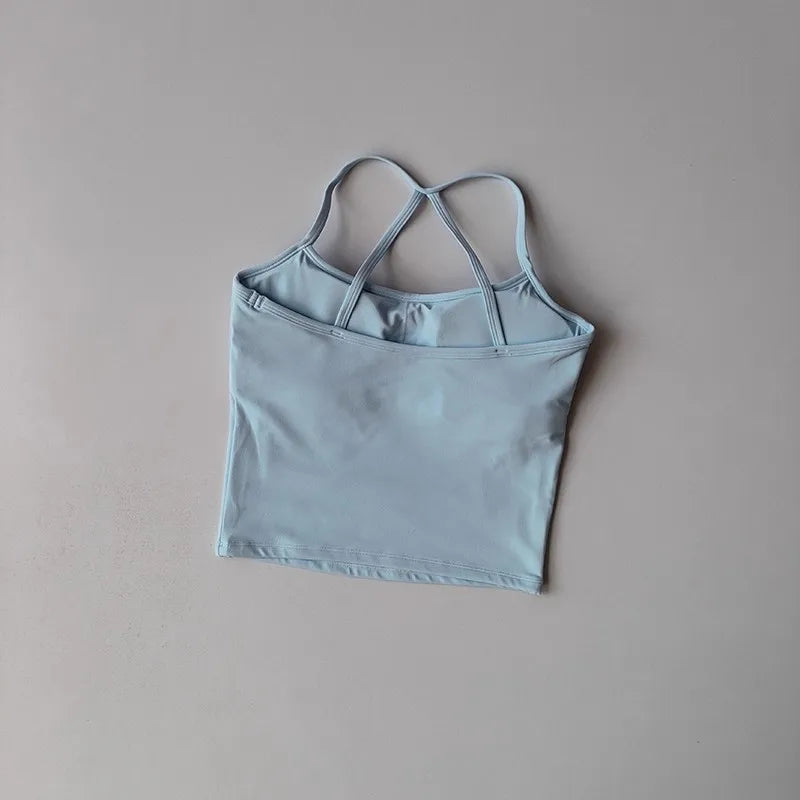 Light blue crop top with thin straps on a beige background