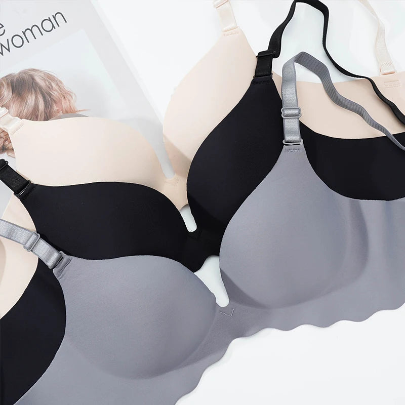 Black and gray bras displayed on a white background with 'The Woman' branding.