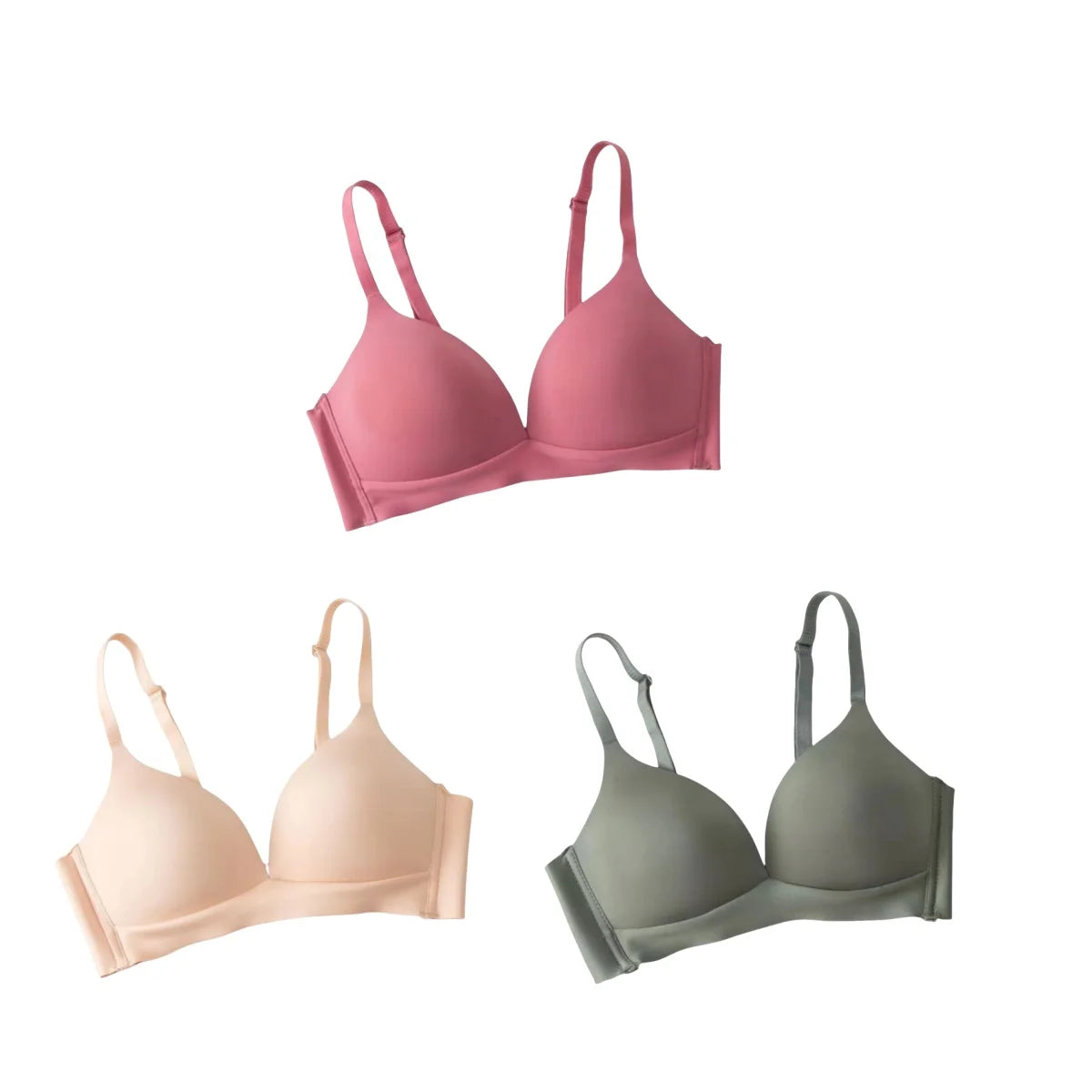 Three bras in pink, beige, and green on a white background