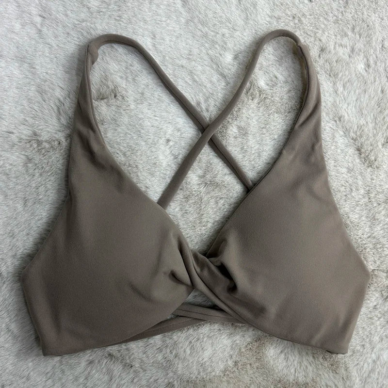 Brown bikini top on a textured gray surface