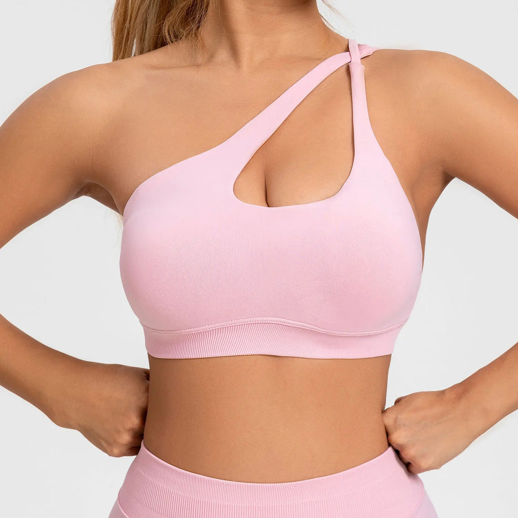 Person wearing a pink sports bra and leggings on a light gray background