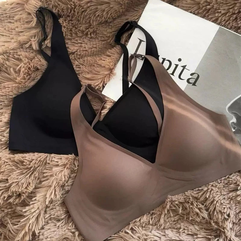 Black and brown bras on a textured surface with a magazine underneath.