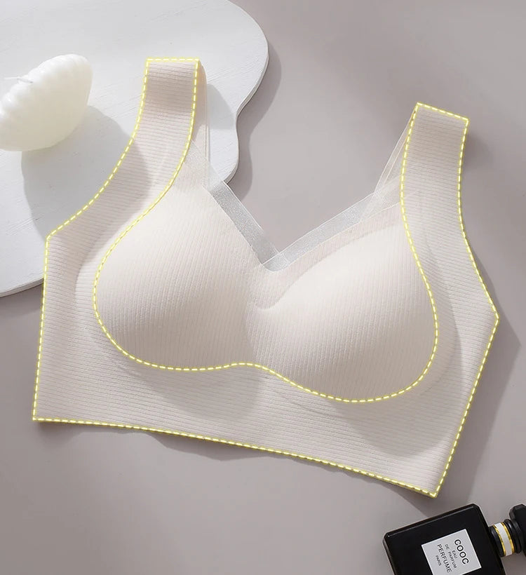 White bra with yellow stitching on a gray background