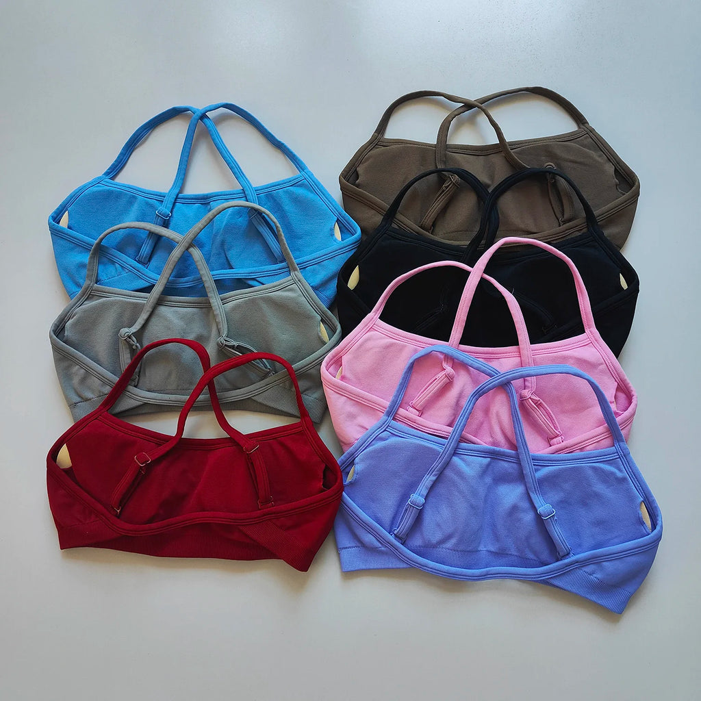 Set of colorful bras arranged on a light gray background