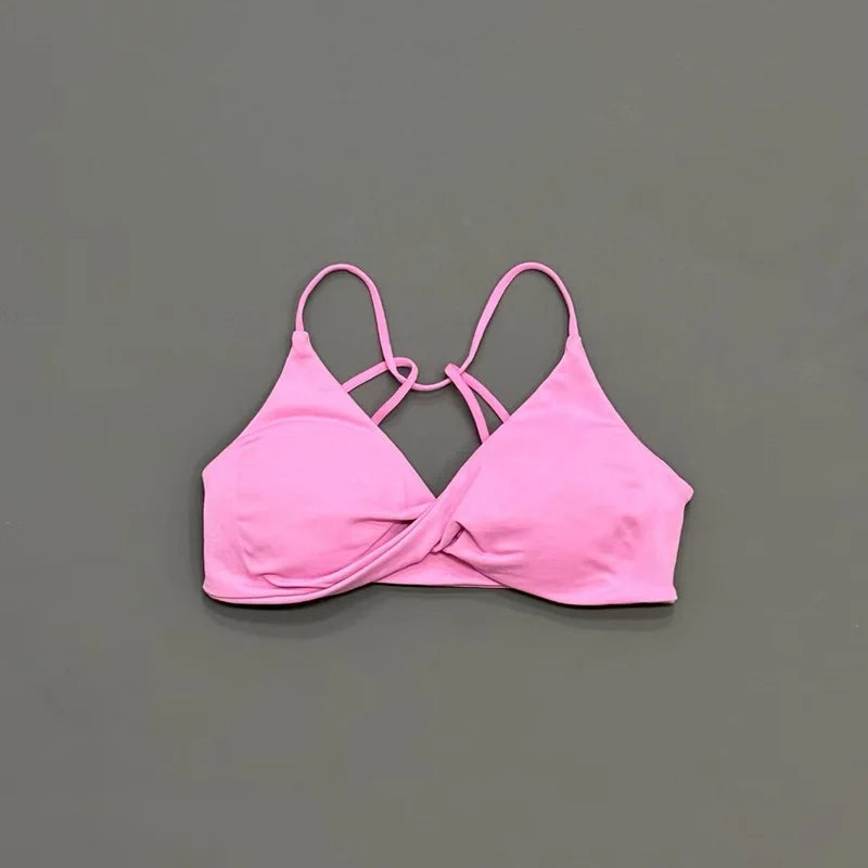 Pink bikini top on a gray background