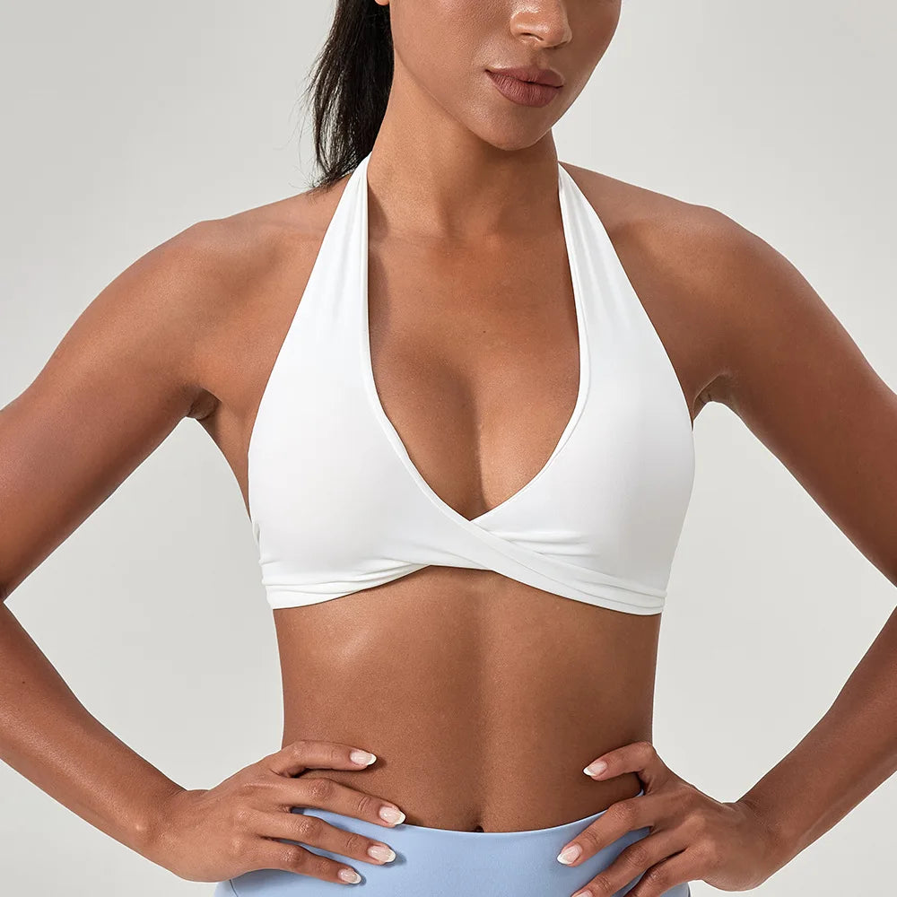 Woman wearing a white bikini top against a neutral background