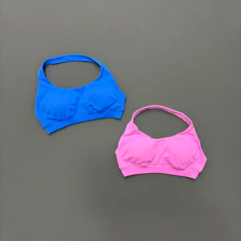 Blue and pink sports bras on a gray background