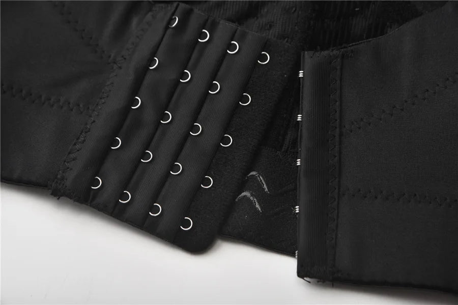 Close-up of a black garment with metal rings on a white background