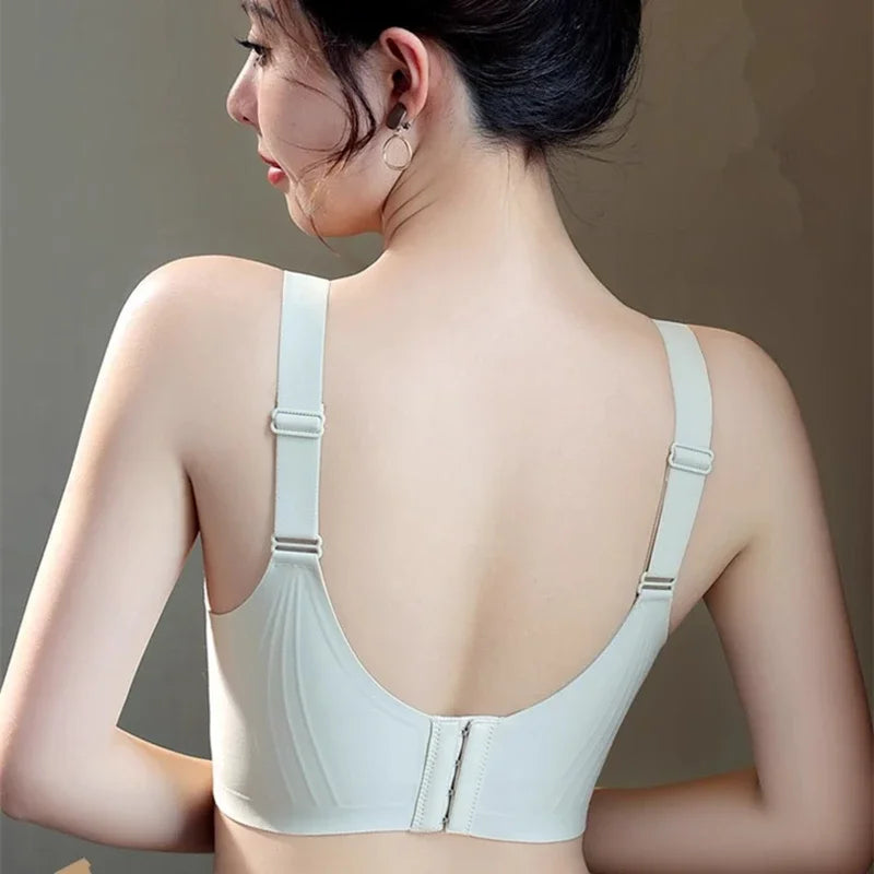 Woman wearing a light gray bra against a neutral background