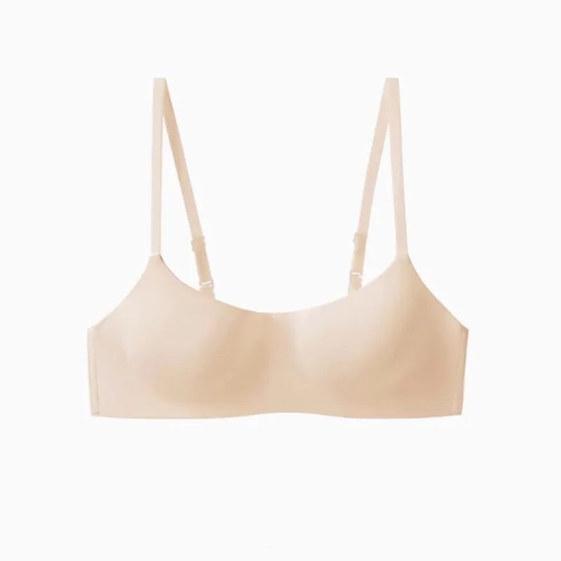 A light beige wireless bra with thin adjustable shoulder straps, shown against a plain white background.