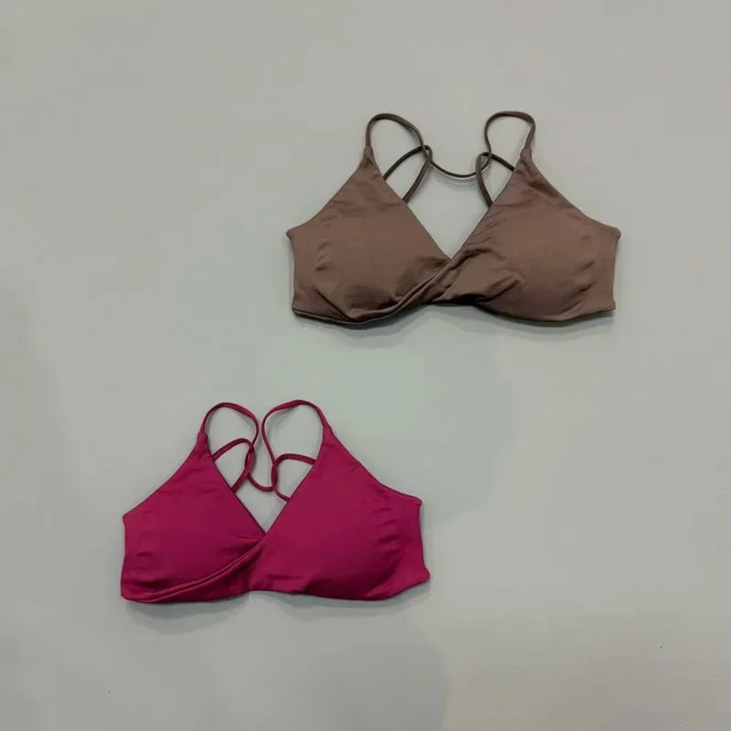 Brown and pink bikini tops on a light gray background