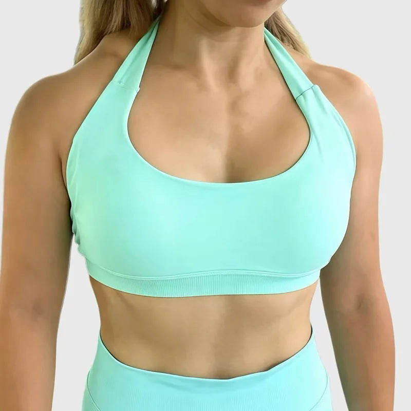 Person wearing a light blue sports bra and leggings on a plain background