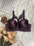 Purple bra with lace details on a white surface with flowers and a keyboard.