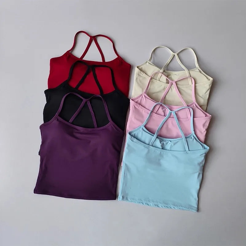 Set of five strappy tops in various colors on a gray background