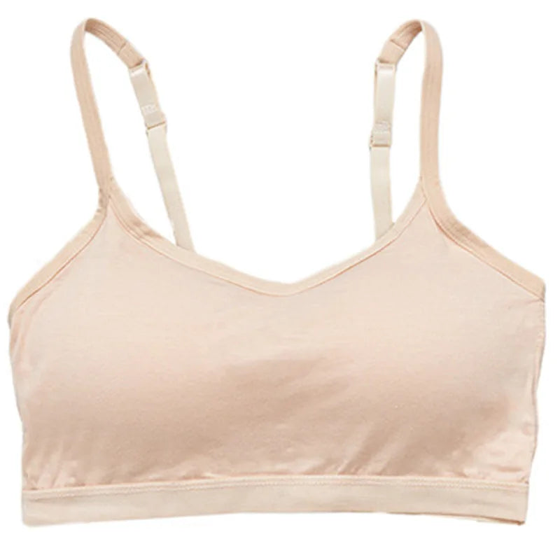 A light beige wireless bralette with adjustable shoulder straps and a wide underband, shown against a plain white background.