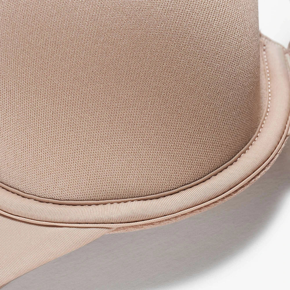 Close-up detail of a light beige straw hat showing the woven texture of the crown and the stitched edge of the brim.