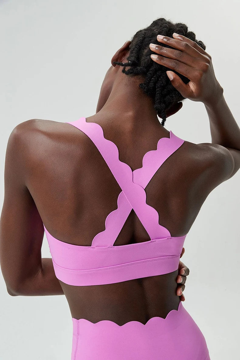 Person wearing a pink sports bra and leggings against a white background