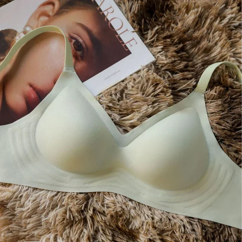 Beige bra on a fluffy brown surface with a magazine underneath