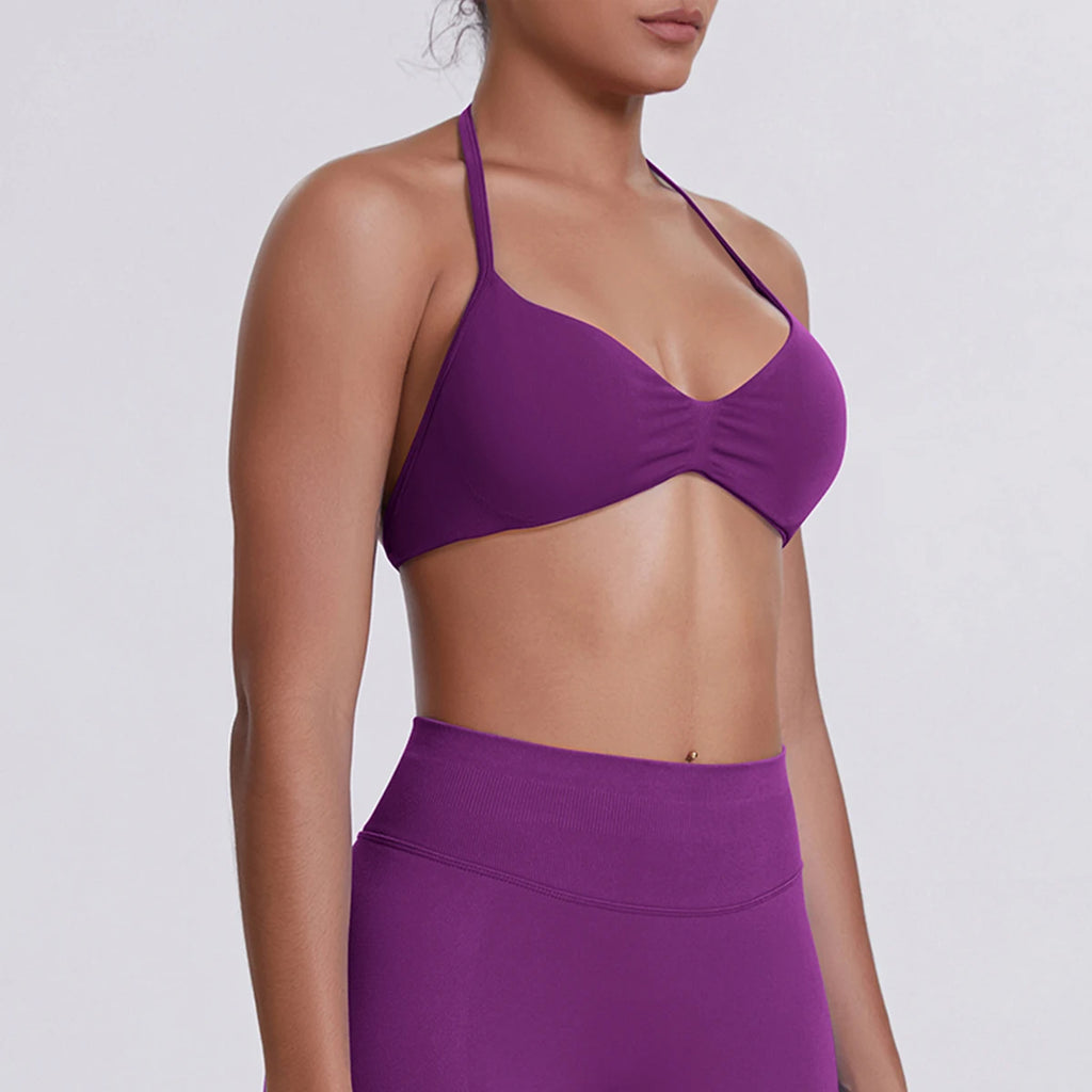Person wearing a purple bikini set on a plain background