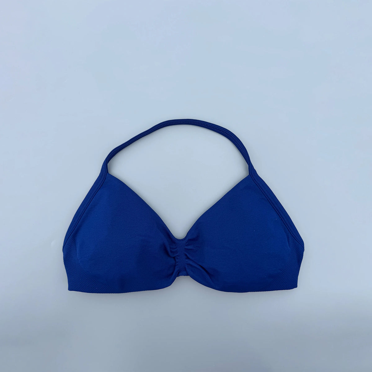 Blue bikini top on a light blue background