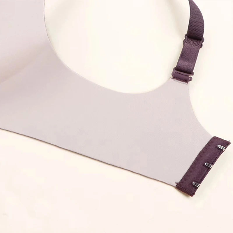 Close-up of a gray bra with purple straps on a light background