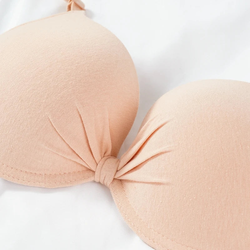 Beige strapless bra on a white background