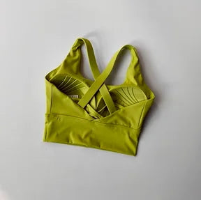 Green sports bra on a light gray background