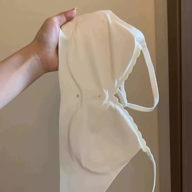 White bra held up against a neutral background