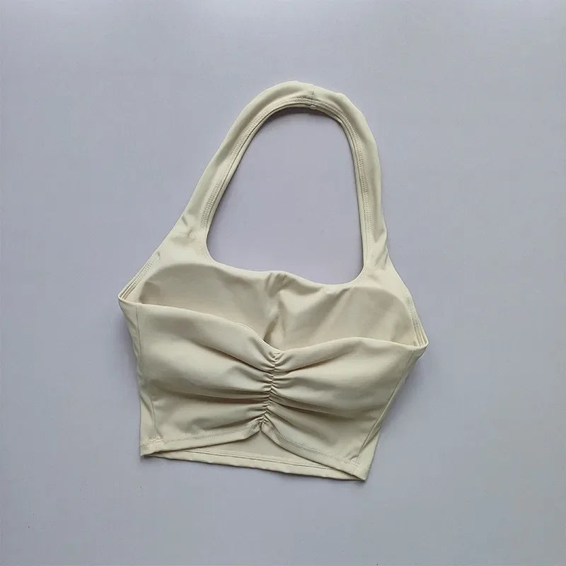 Beige ruched top on a gray background