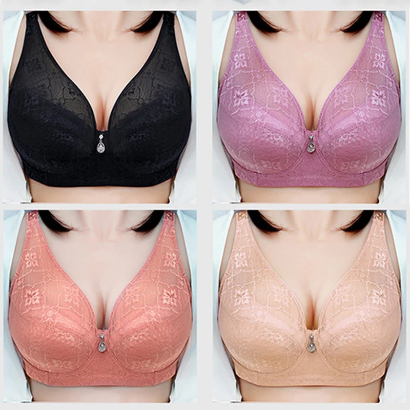 Four lace underwire bras shown in a 2x2 grid: black, dusty pink, coral pink, and nude beige. Each bra features a V-neckline, floral lace pattern, and a small teardrop crystal pendant at the center gore.