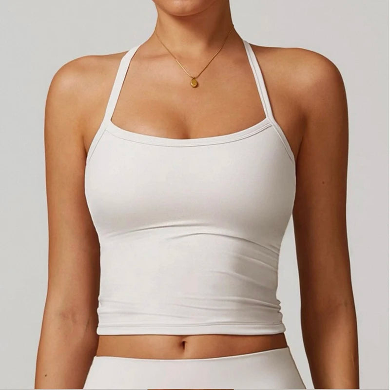 White tank top worn by a person on a plain background