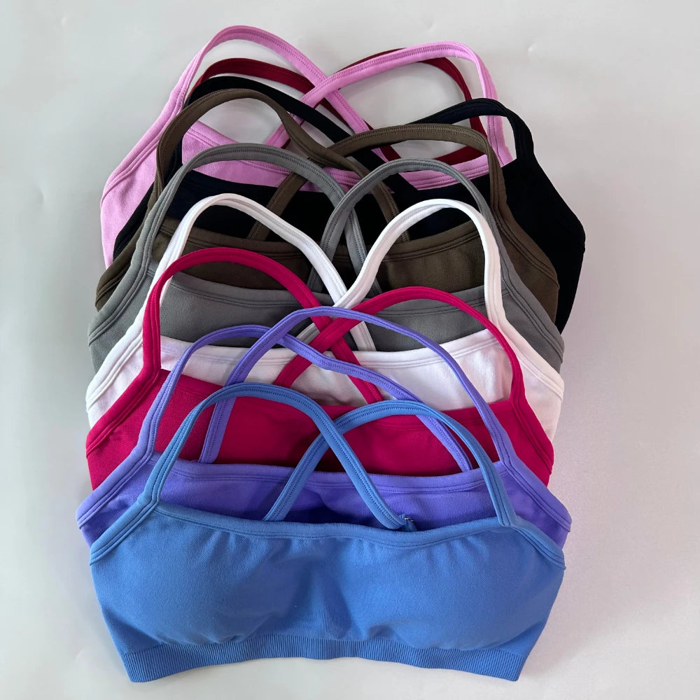 Stack of colorful bras on a light gray background