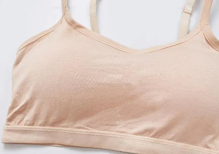 A close-up of a light beige or nude-colored bra cup and underband, photographed against a plain white background.