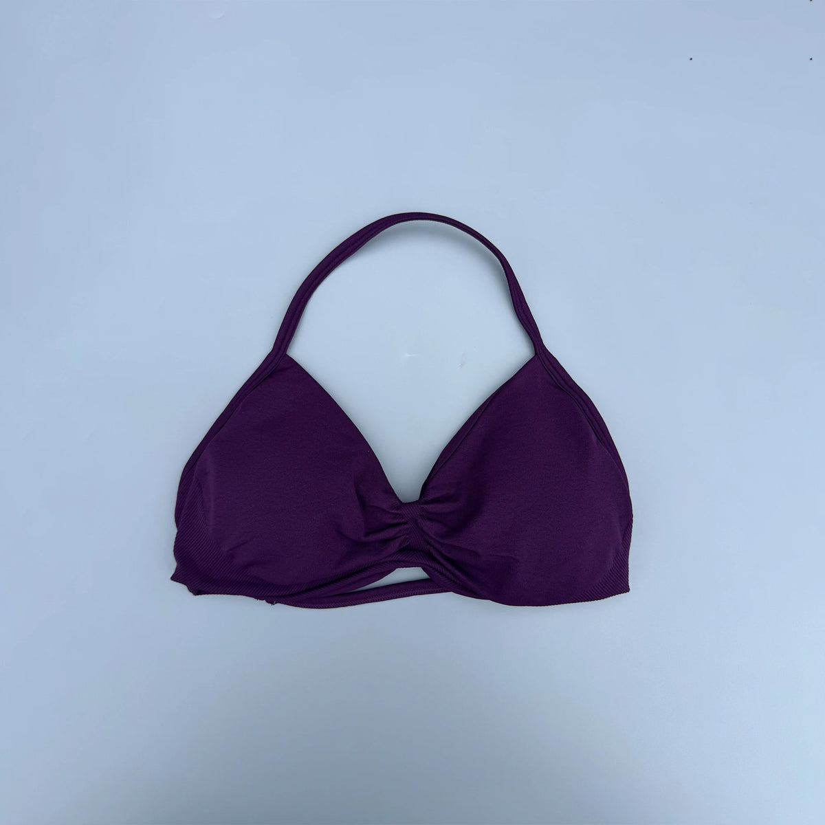 Purple bikini top on a light blue background