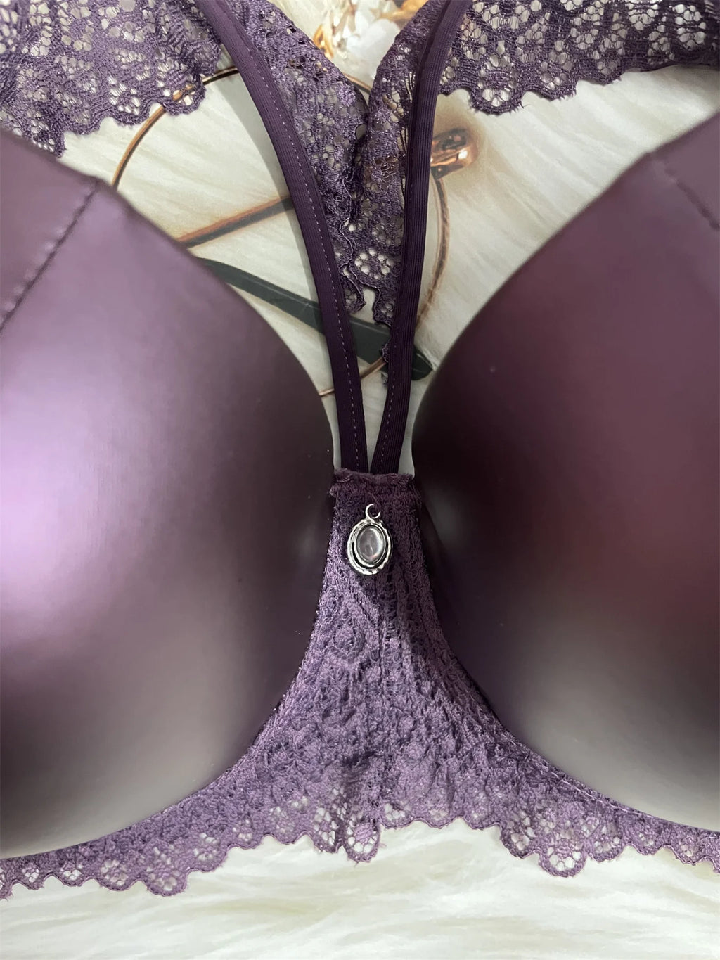 Purple lace bra on a white surface