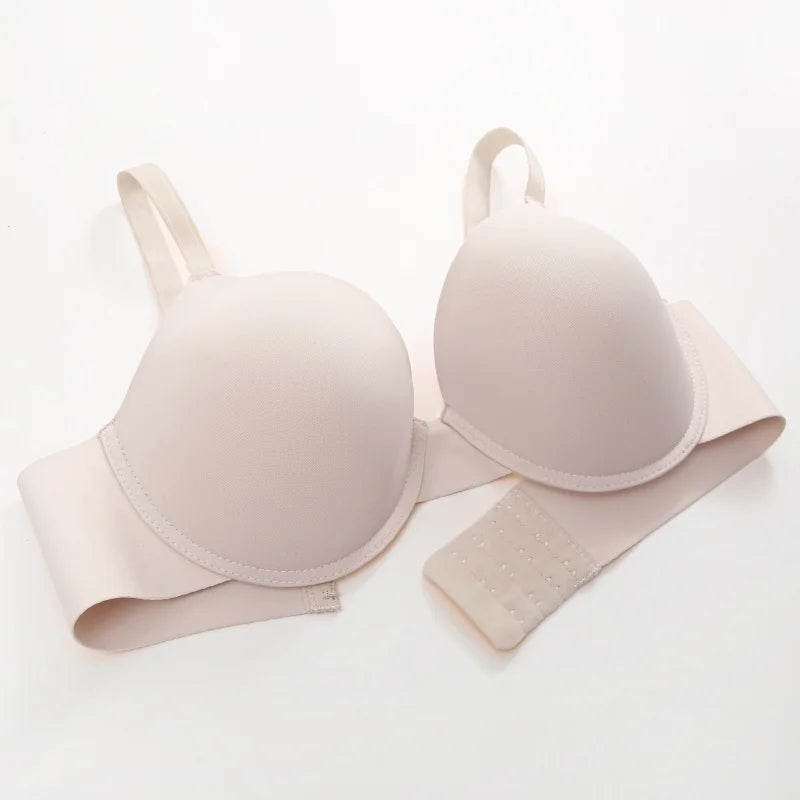 A light beige wireless underwire bra with adjustable straps and a matching supportive band, displayed on a clean white background.