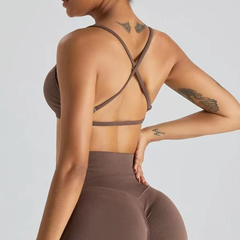 Person wearing a brown sports bra and leggings set on a light gray background