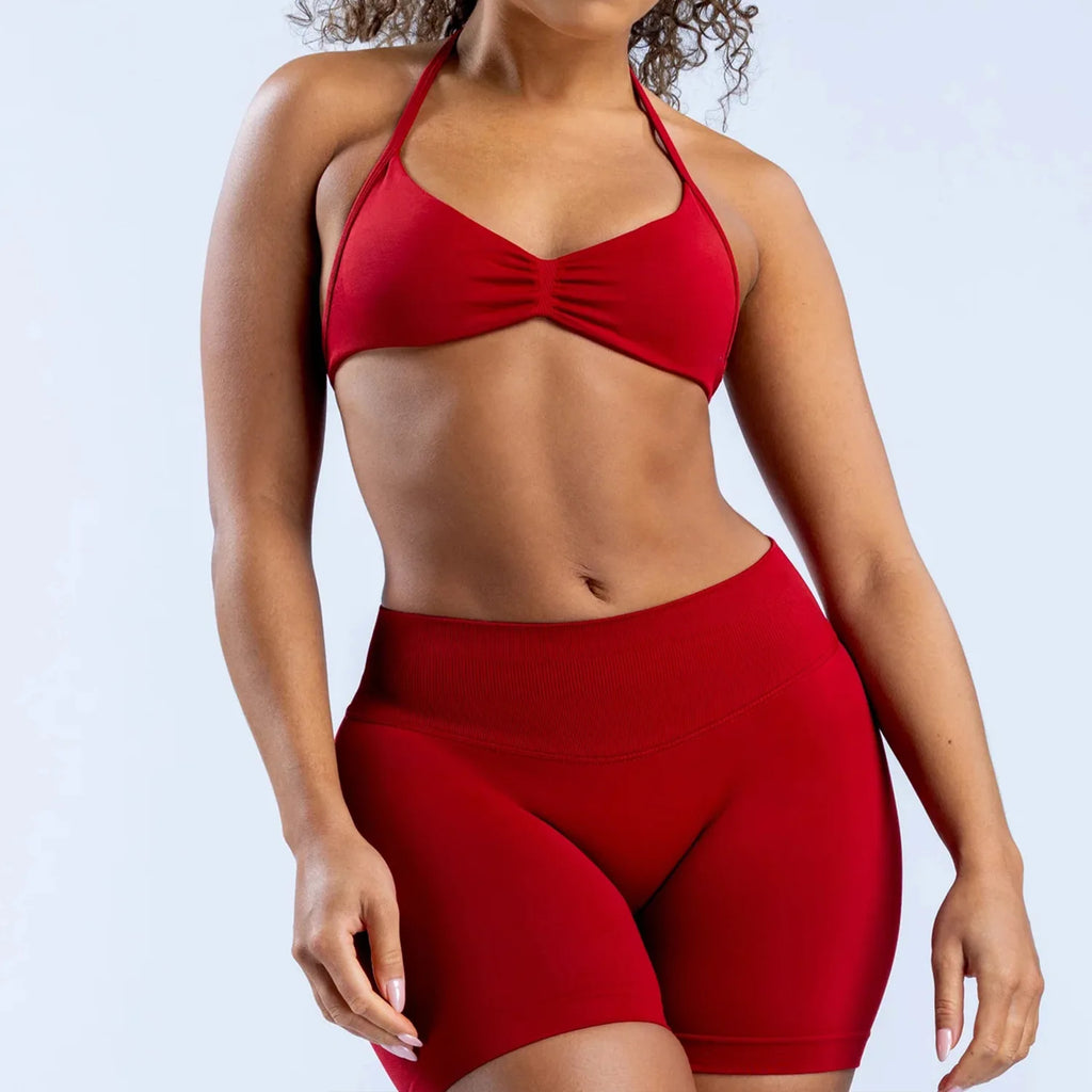 Woman wearing a red bikini set on a light gray background