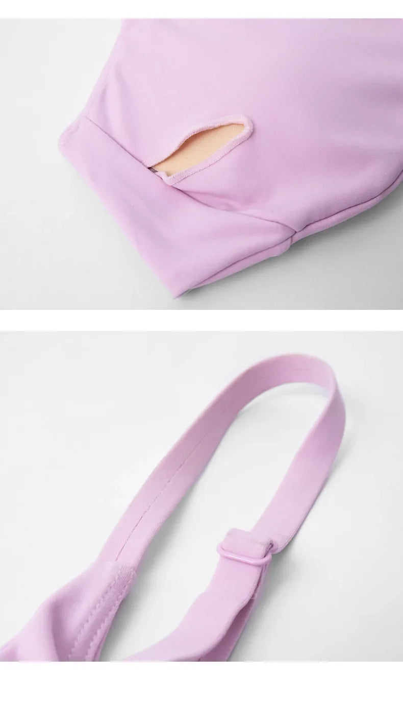 Purple baby carrier with a strap on a light gray background