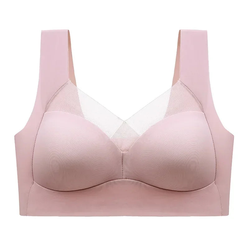 A light pink wireless bra with wide shoulder straps and a sheer mesh V-neckline detail, shown against a plain white background.