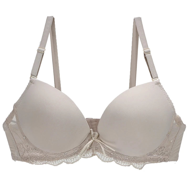 Beige bra with lace details on a white background