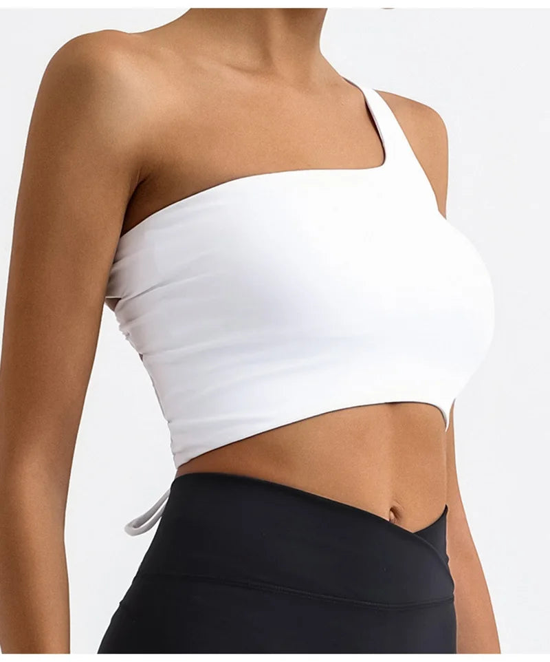 White one-shoulder top worn by a person on a white background