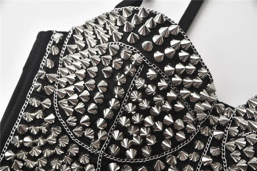 Black backpack with silver studs and chain details on a white background